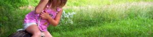 Girl playing on tire swing